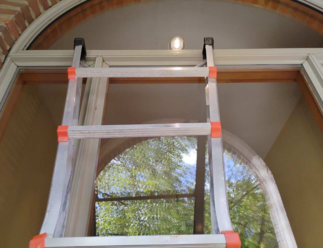 closeup of ladder leaning against residential window