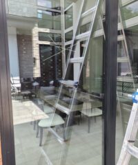 residential window with reflection of a frame ladder